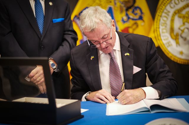 New Jersey Gov. Phil Murphy signs a bill requiring licensure for police. Social justice advocates say it's a positive step, but are calling on the governor to do more for non-white New Jerseyans.